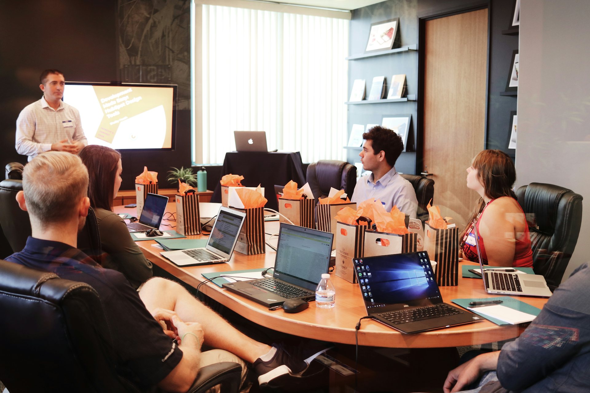 A project team reviewing Odoo requirements around a meeting table