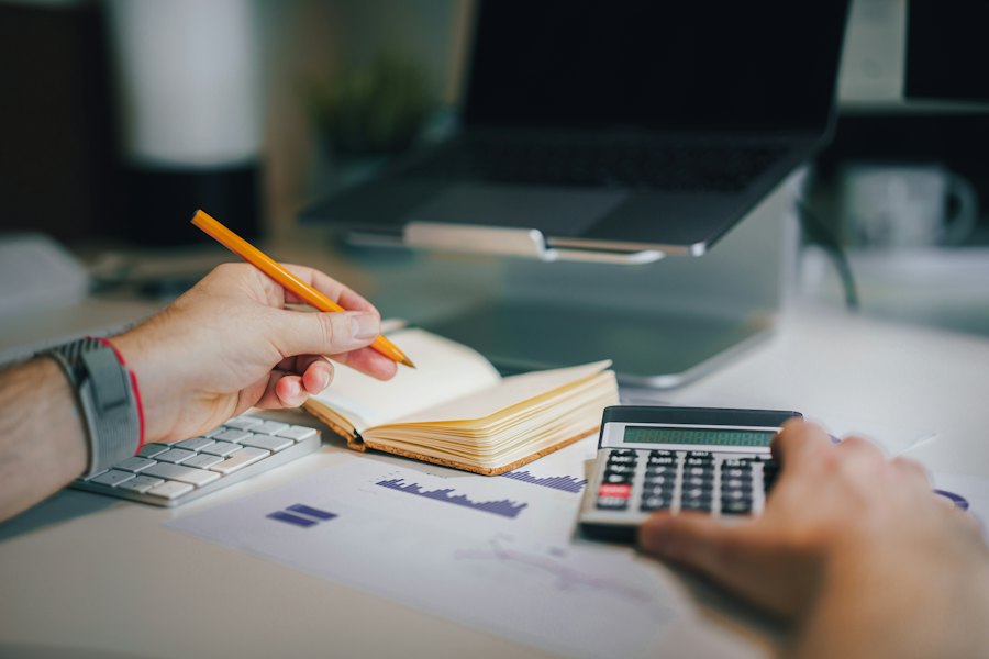 A notebook and calculator on a desk, representing customer billing